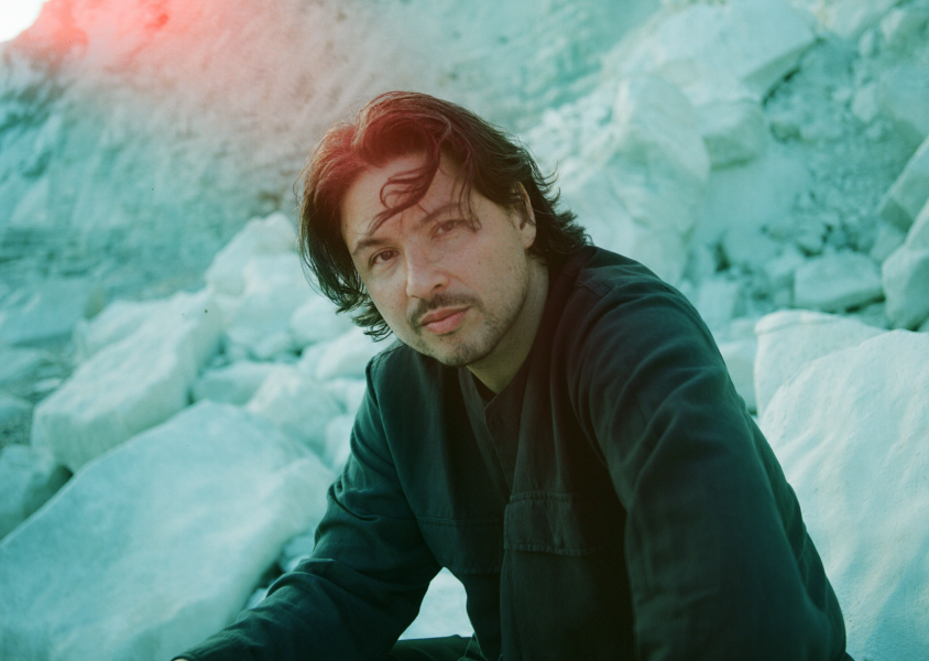 Musician Jamie Moon sitting outsidex